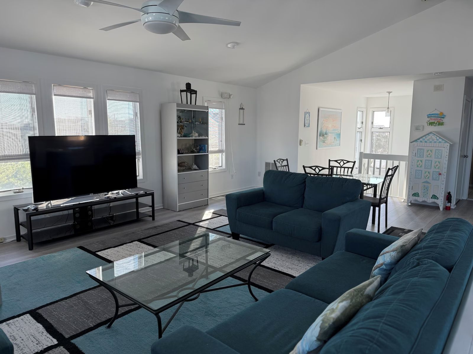 Living room with TV, sofa, and dining area